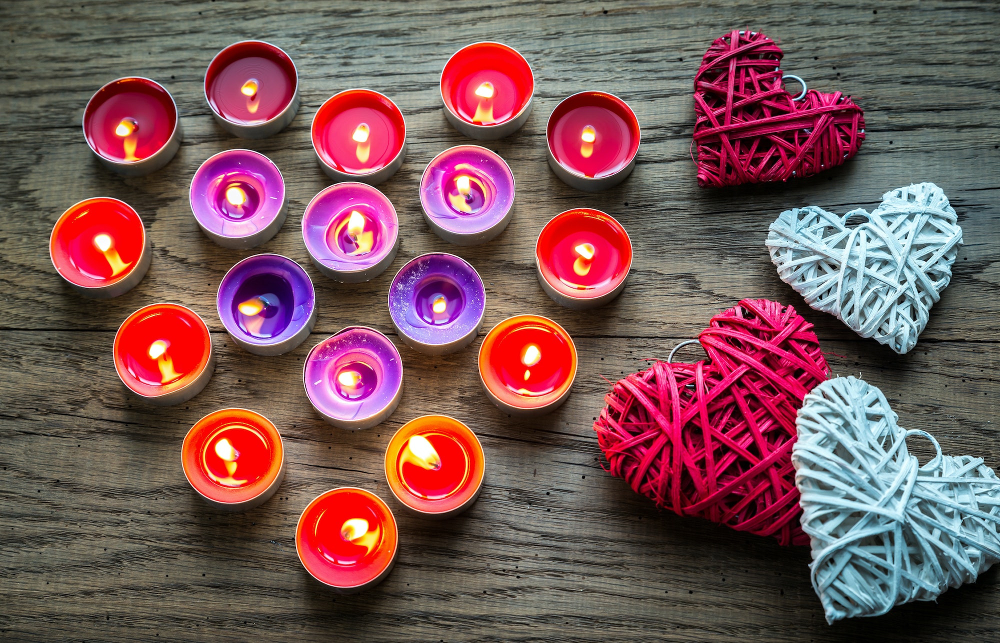 Burning candles with retro cane hearts